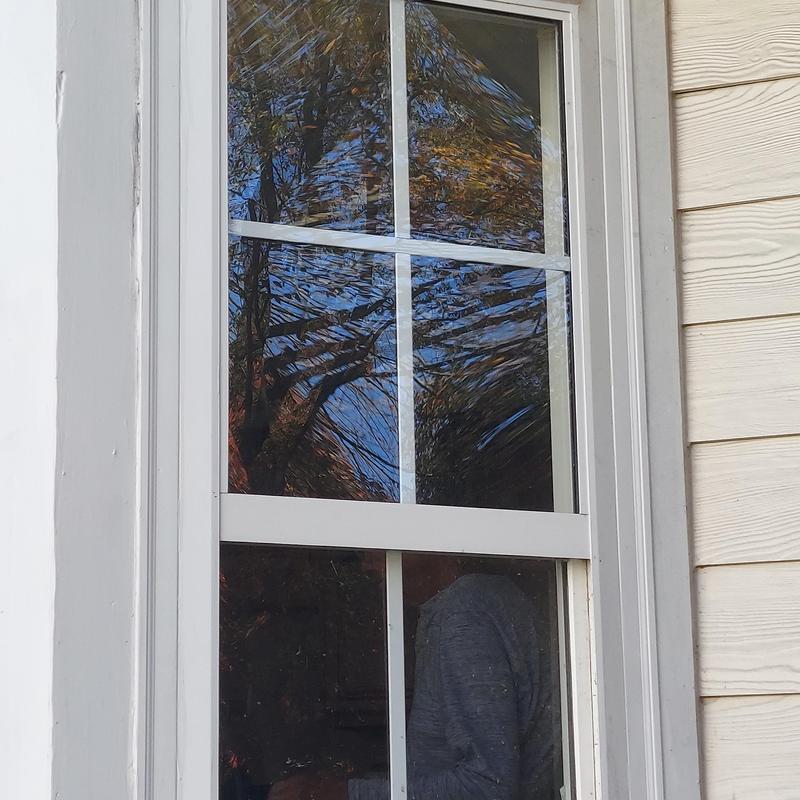 Double-hung window with decorative grid in vinyl frame Double-hung window with decorative grid in vinyl frame