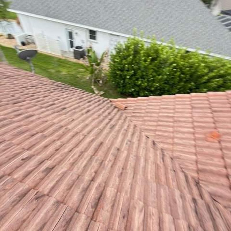 Concrete tile roof with minor damaged tiles visible