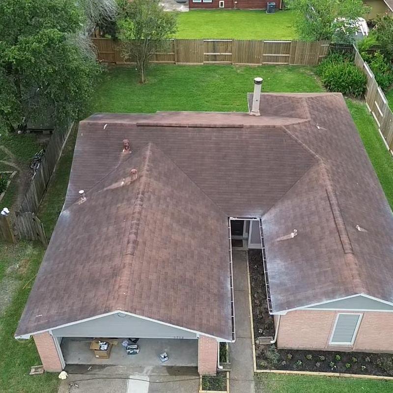 Asphalt shingle roof with gutters before replacement
