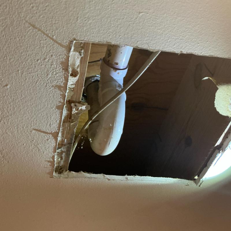 Shower drain pipe visible through ceiling access hole Shower drain pipe visible through ceiling access hole