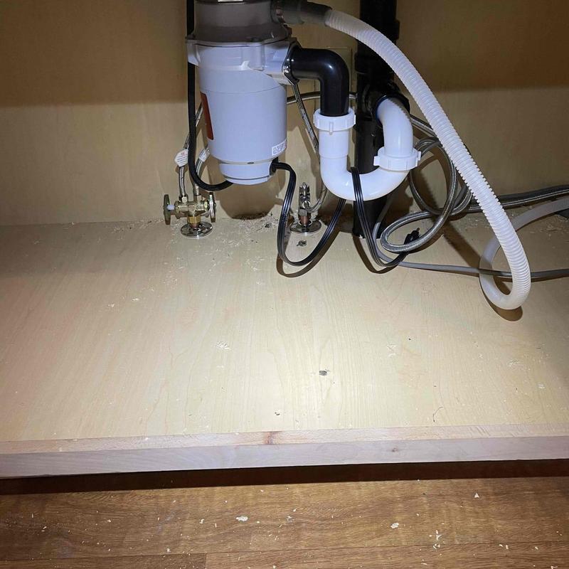 Garbage disposal and sink drain plumbing under kitchen cabinet Garbage disposal and sink drain plumbing under kitchen cabinet