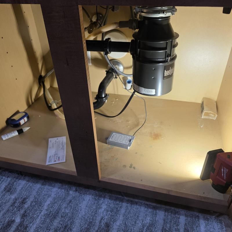 Garbage disposal unit under kitchen sink with tools Garbage disposal unit under kitchen sink with tools