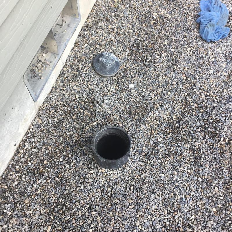 Mainline sewer cleanout open on gravel surface Mainline sewer cleanout open on gravel surface
