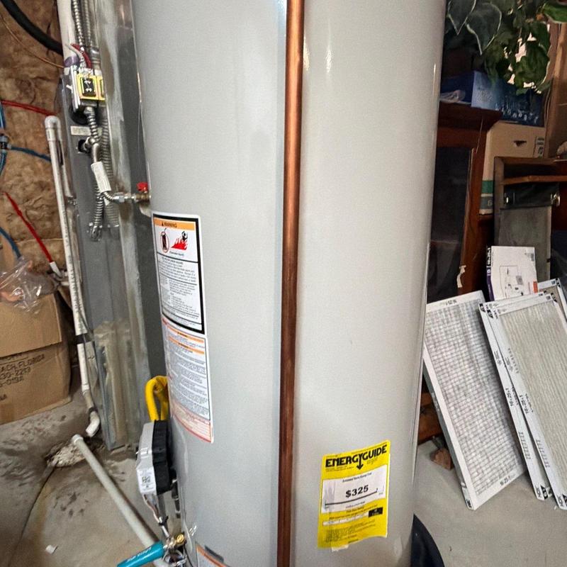 Water heater with copper pipe installation in utility room Water heater with copper pipe installation in utility room
