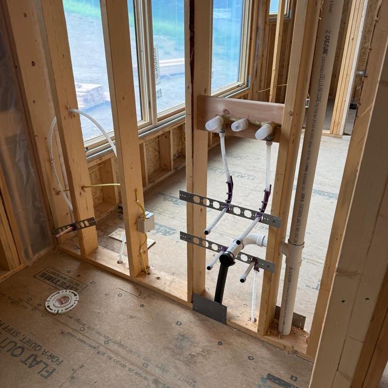 Plumbing rough-in with water lines and drain pipes