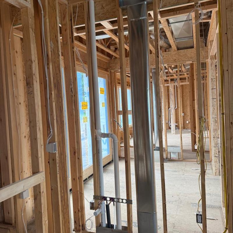 PVC plumbing pipes and metal ductwork rough-in in home