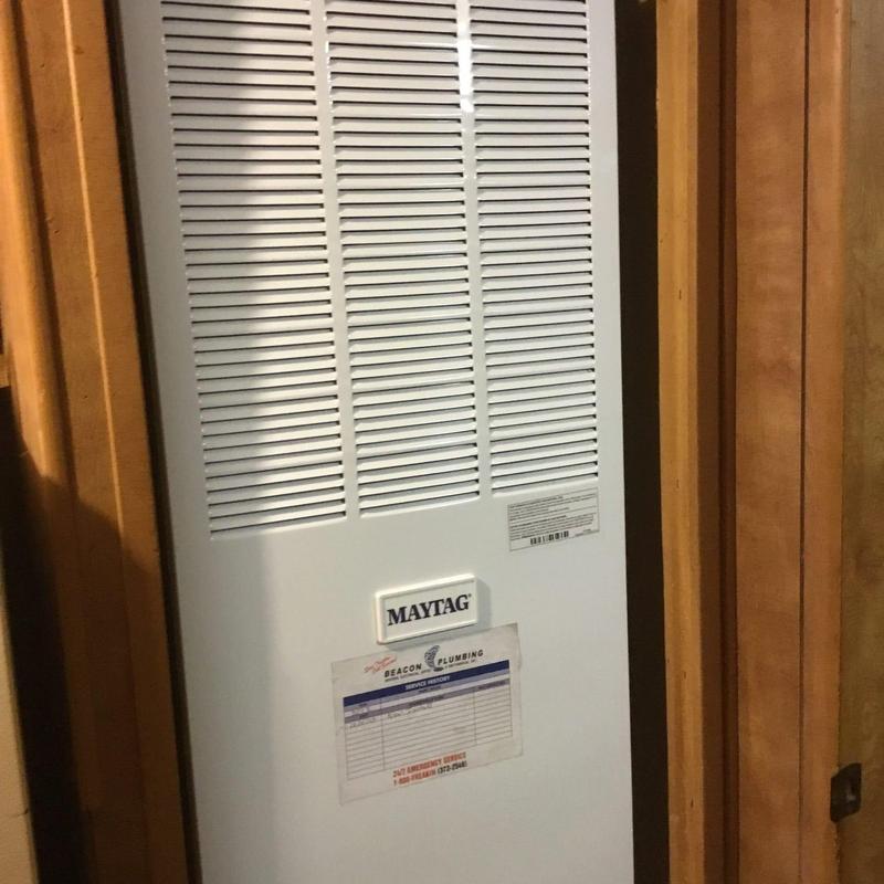 Maytag furnace in wood-paneled closet installation Maytag furnace in wood-paneled closet installation