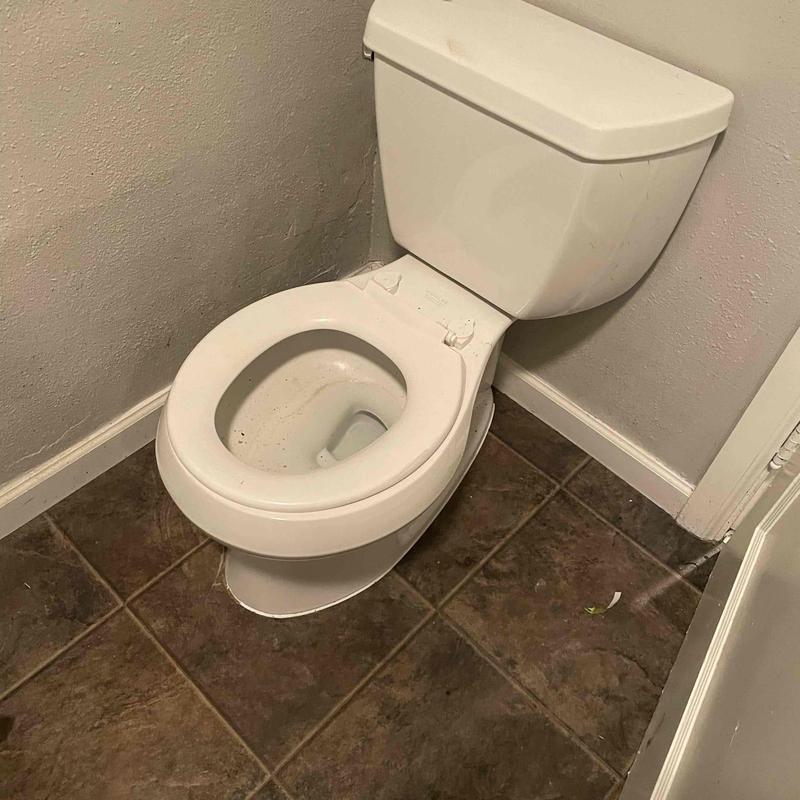 Toilet bowl with removed toilet seat on tiled floor Toilet bowl with removed toilet seat on tiled floor