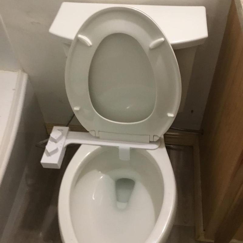 Elongated toilet with bidet sprayer rehooked Elongated toilet with bidet sprayer rehooked