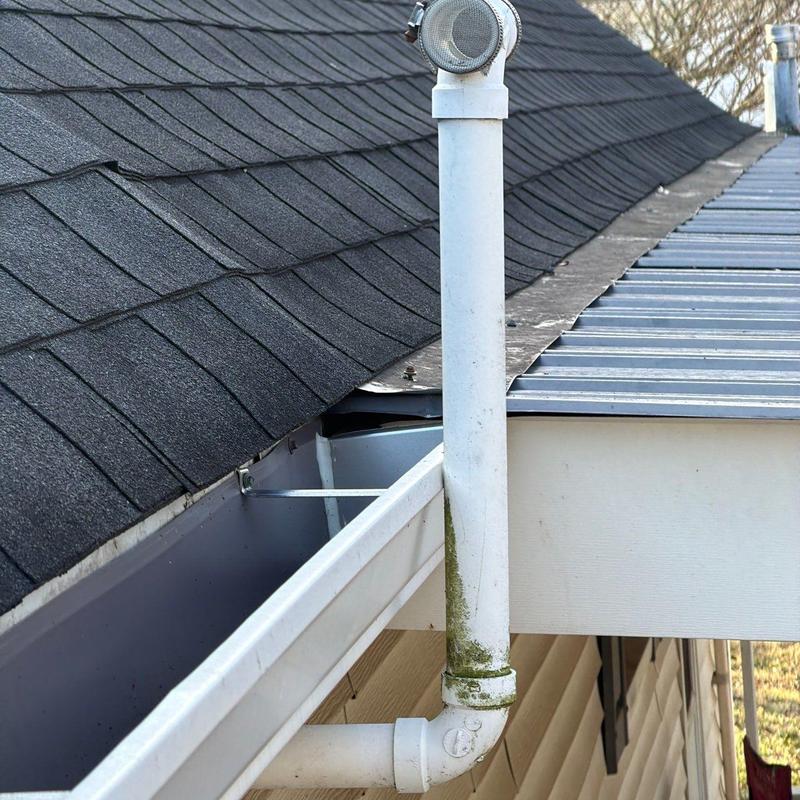 Gutter system with downspout vent on shingled roof