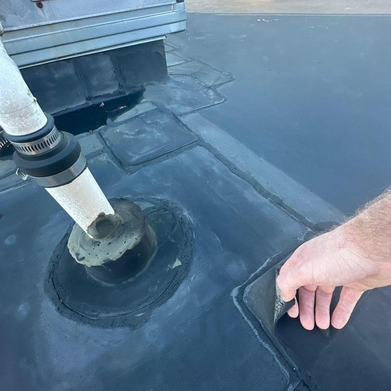 EPDM roofing membrane patch near pipe flashing EPDM roofing membrane patch near pipe flashing