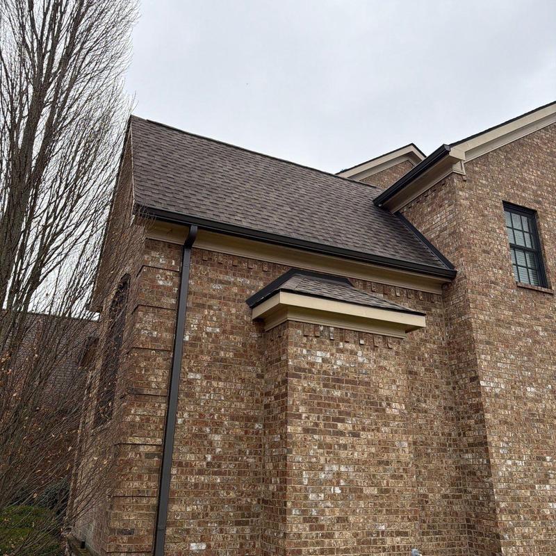Asphalt shingle roof and gutter system on brick home