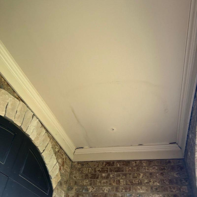 Ceiling drywall with water stains and damage near entryway
