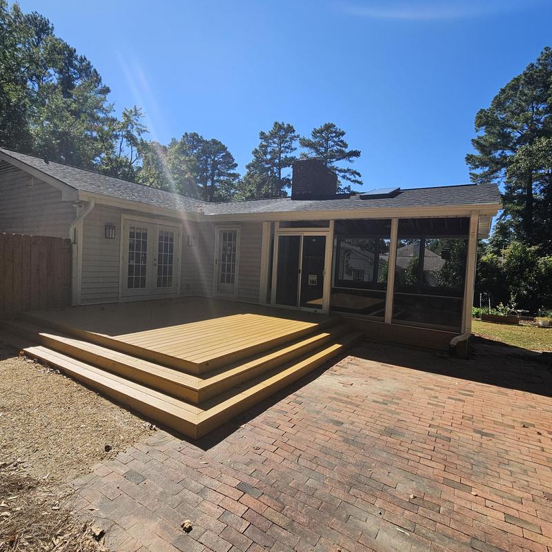 Wooden deck and screened porch installation in backyard Wooden deck and screened porch installation in backyard