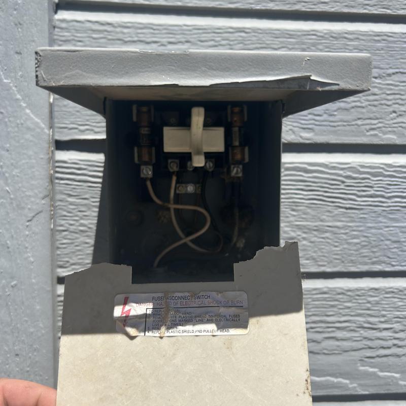 Air conditioning disconnect with damaged cover and wiring