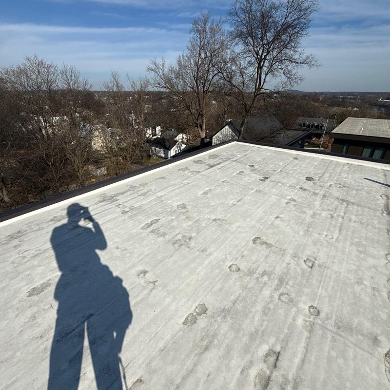 Flat roof membrane showing hail impact damage spots