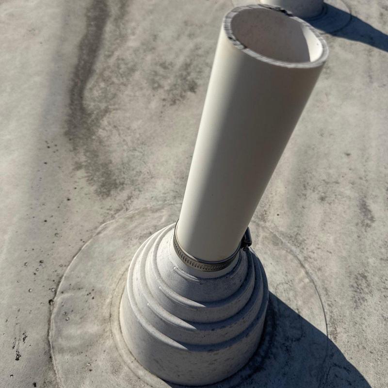 Roof pipe flashing seal with clamp on flat roof