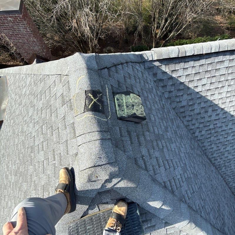Roof shingles with hail damage marked for repair