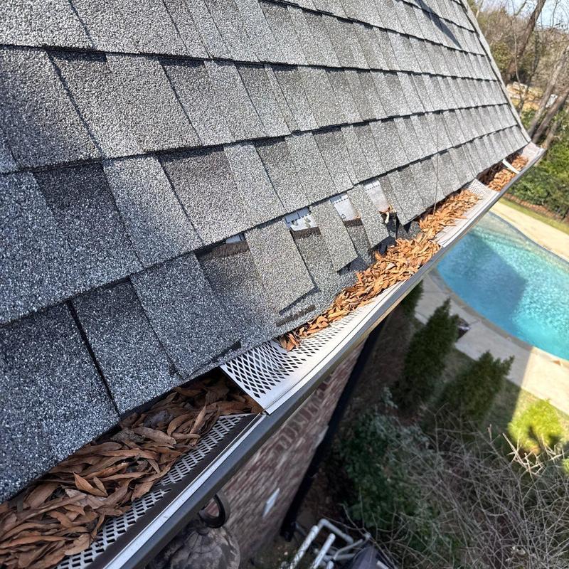 Asphalt shingle roof with damaged and missing shingles