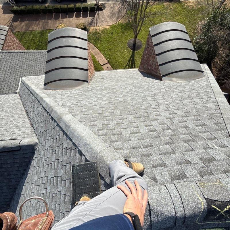 Asphalt shingle roof with damaged ridge cap inspection