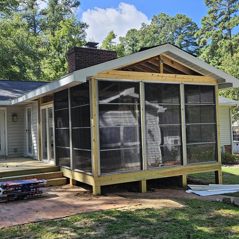 Screened porch addition framing on home exterior Screened porch addition framing on home exterior