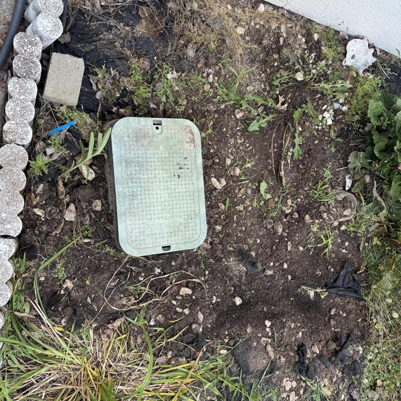 Water pressure regulator box installation in yard dirt Water pressure regulator box installation in yard dirt