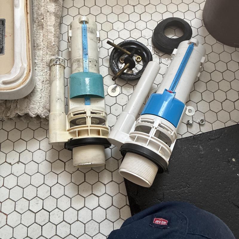Toilet Fill Valve and Flush Valve Components on Floor