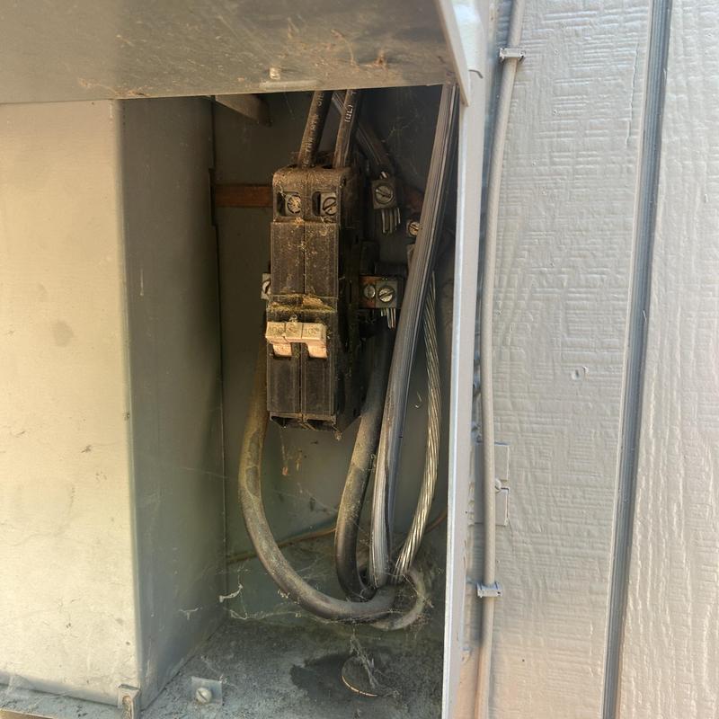 Breaker inside electrical panel showing worn wiring