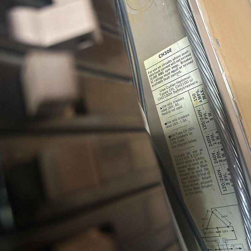Electrical panel label showing breaker specifications and warnings