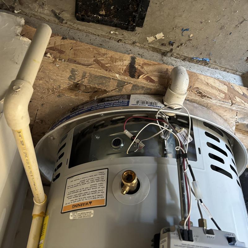 Water heater with exposed wiring and plumbing connections