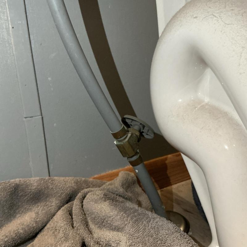 Emergency stop valve under toilet with towel placed nearby Emergency stop valve under toilet with towel placed nearby