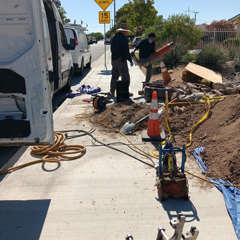 Trenchless sewer liner installation on street sidewalk