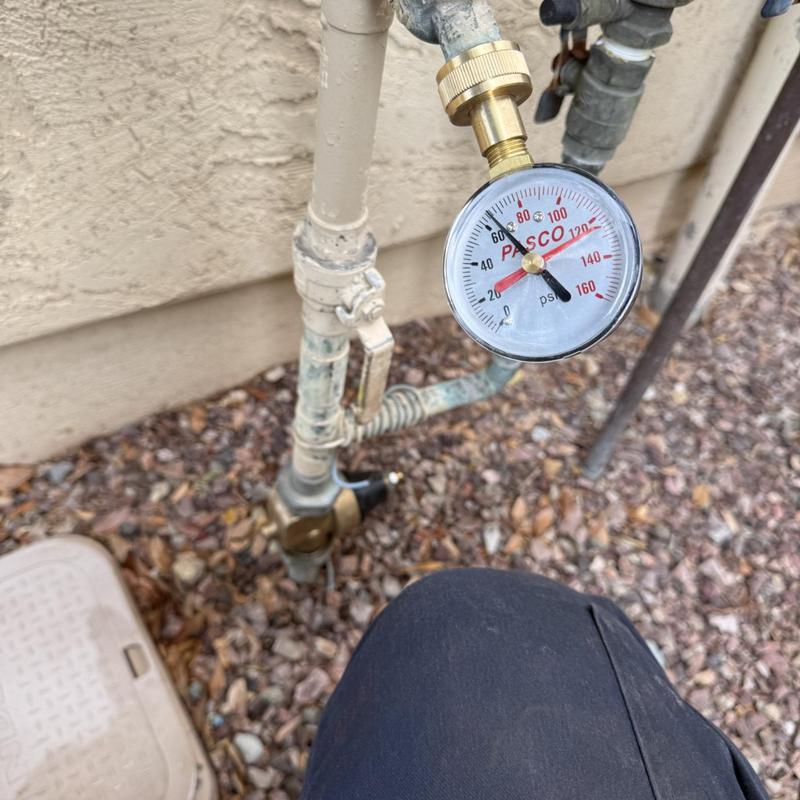 Water pressure gauge on outdoor plumbing line