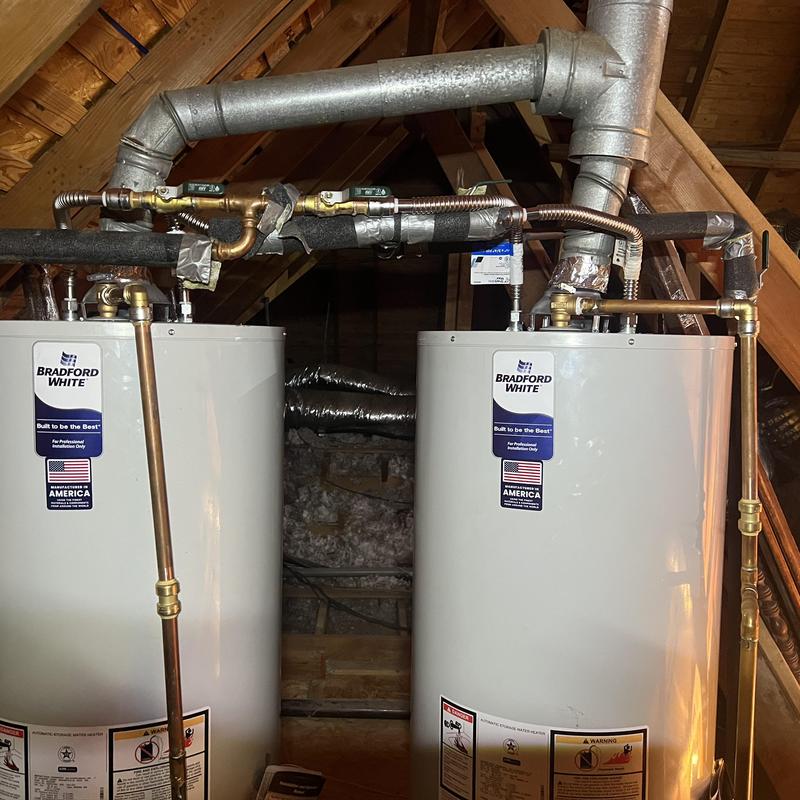 50-gallon gas water heaters with settlement traps in attic