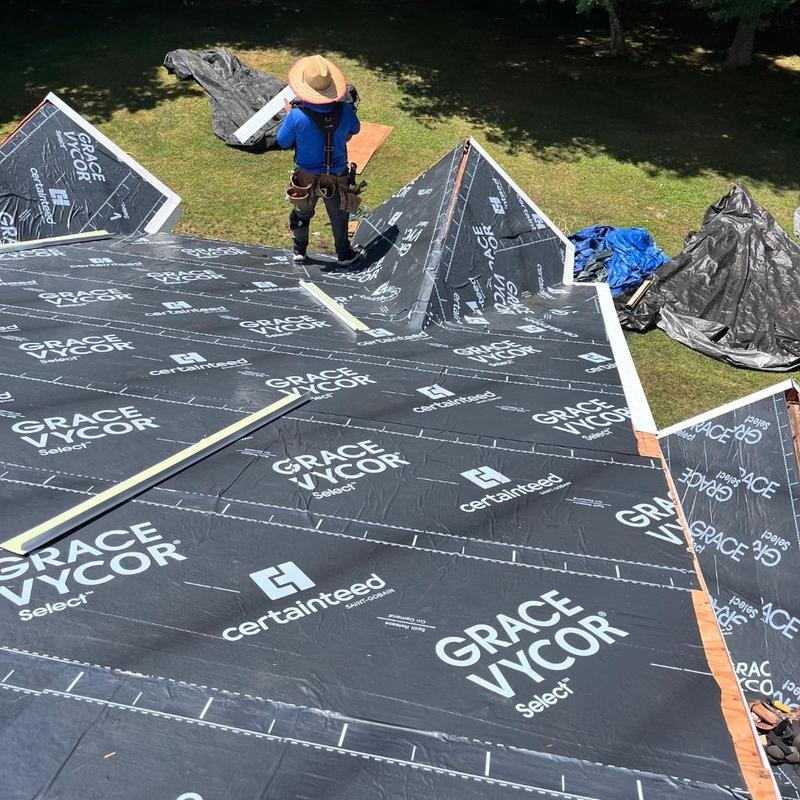 Roof underlayment installation with worker in East Lyme CT Roof underlayment installation with worker in East Lyme CT