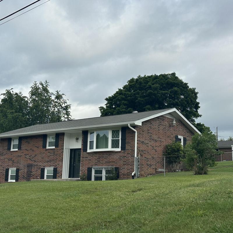 Asphalt shingle residential roof on brick house Asphalt shingle residential roof on brick house
