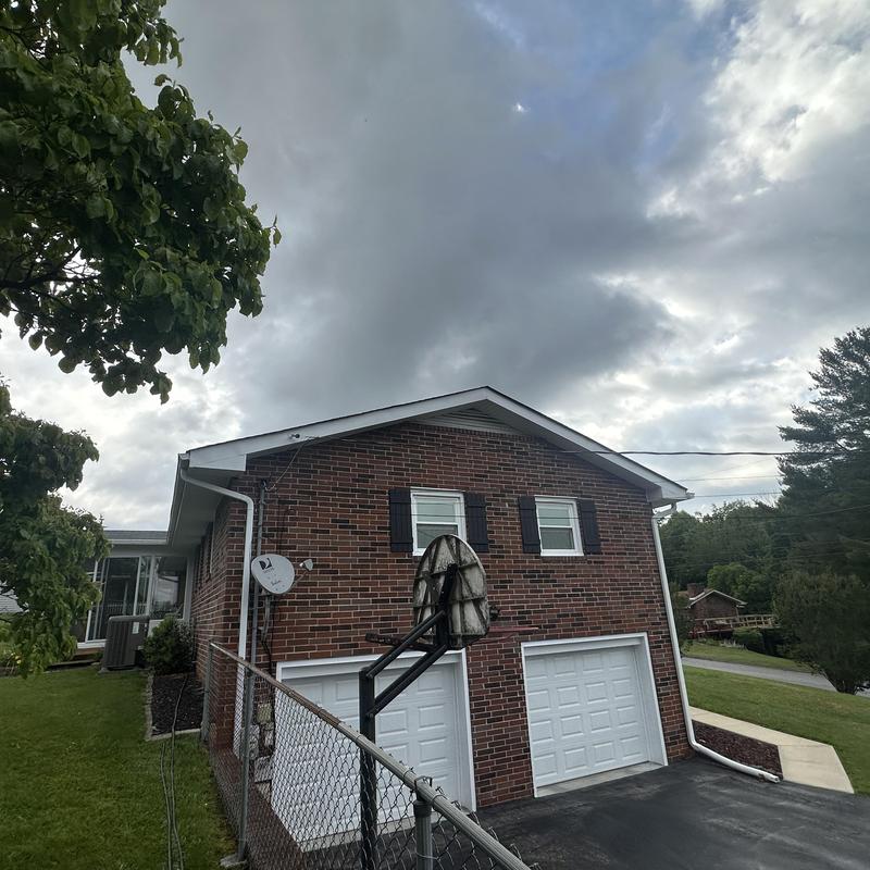 Residential shingle roof with brick exterior and garage Residential shingle roof with brick exterior and garage