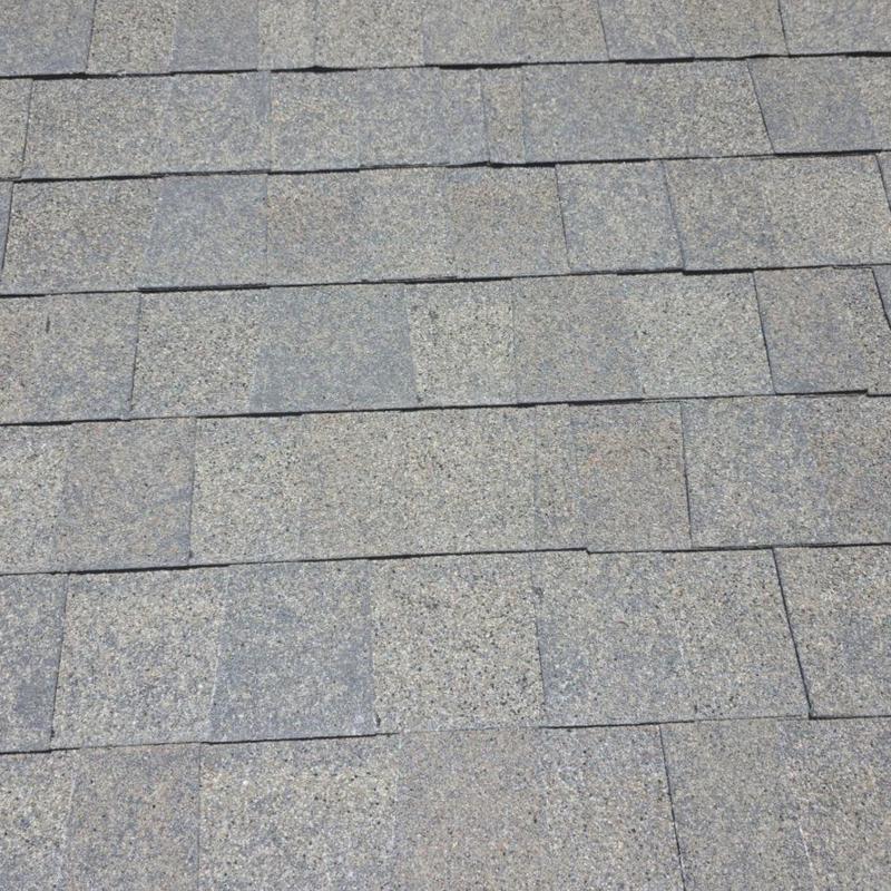 Architectural shingles showing hail impact damage