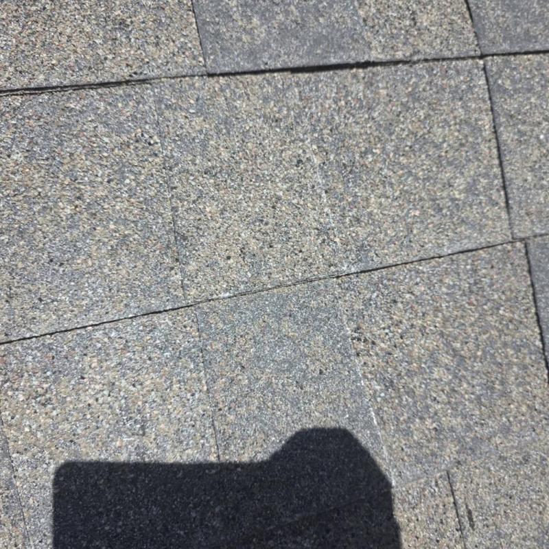 Architectural shingles with hail damage and missing granules