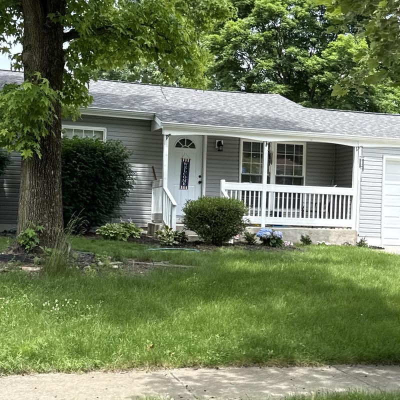 Asphalt shingle roof with gutter and siding damage