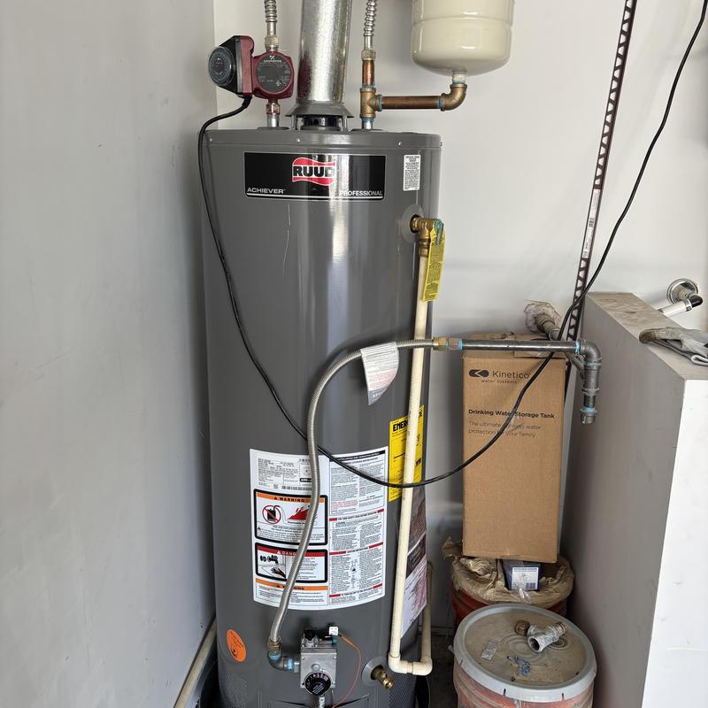 Water heater tank with plumbing connections and vent pipe