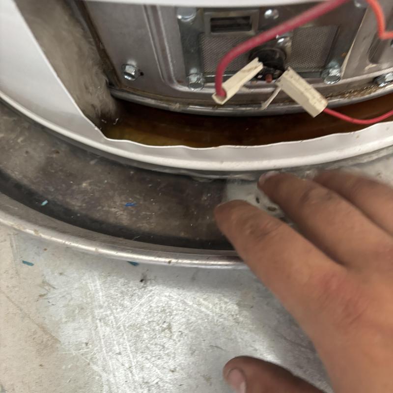 Water heater tank showing internal damage and wiring