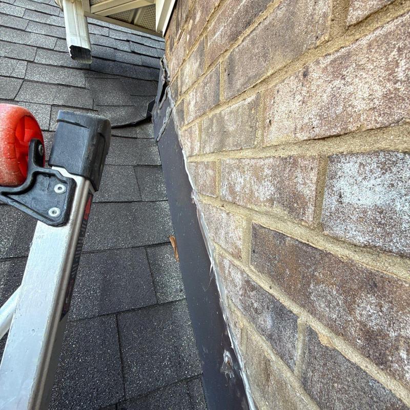 Roof flashing with damaged shingle and brick wall sealant