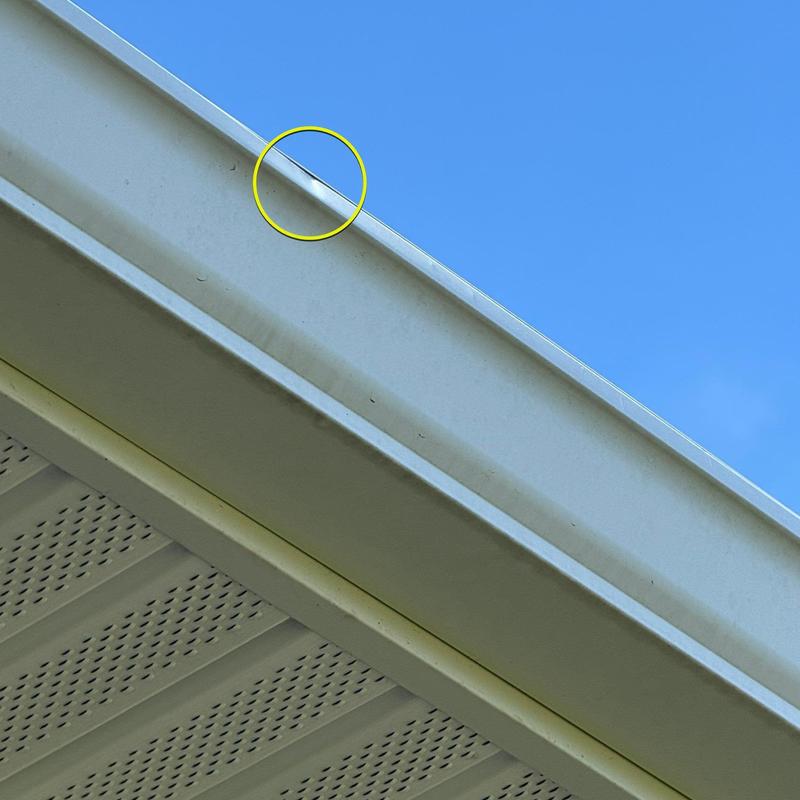 Aluminum gutter dent with roof edge detail