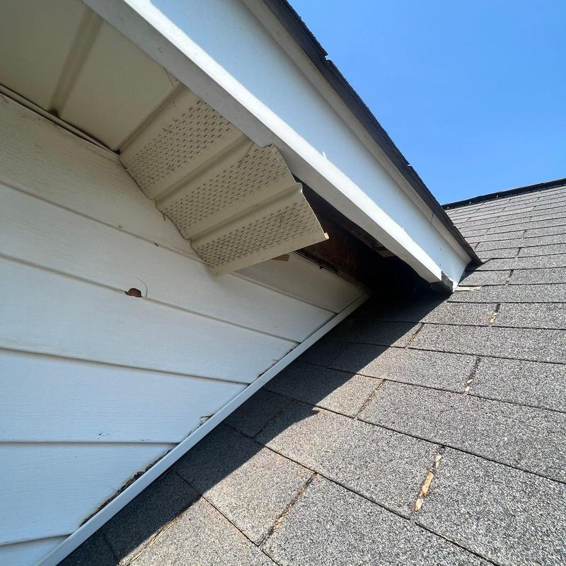 Roof shingles and soffit damage near flashing area