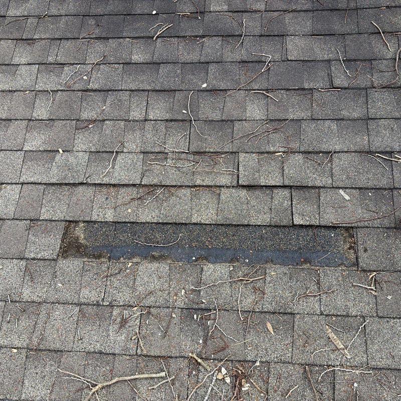 Asphalt roofing shingles with missing shingle section