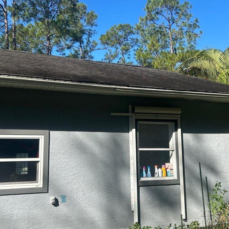 Asphalt shingle roof with gutter edge and stucco wall Asphalt shingle roof with gutter edge and stucco wall