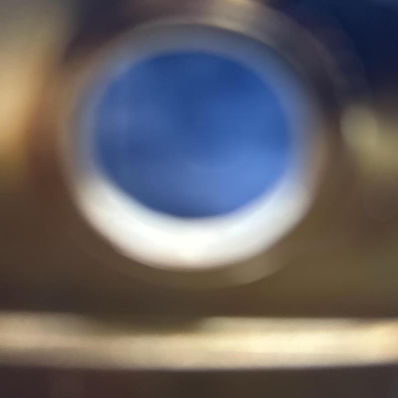 Gas water heater blue flame through sight glass close-up Gas water heater blue flame through sight glass close-up