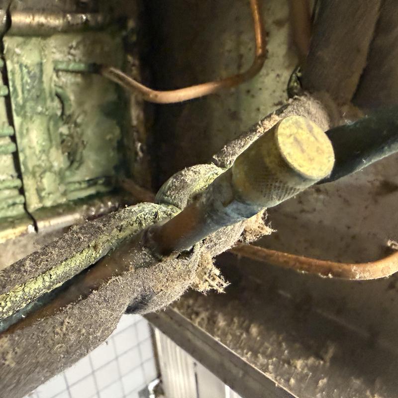Refrigeration copper tubing with insulating wrap and dust buildup Refrigeration copper tubing with insulating wrap and dust buildup