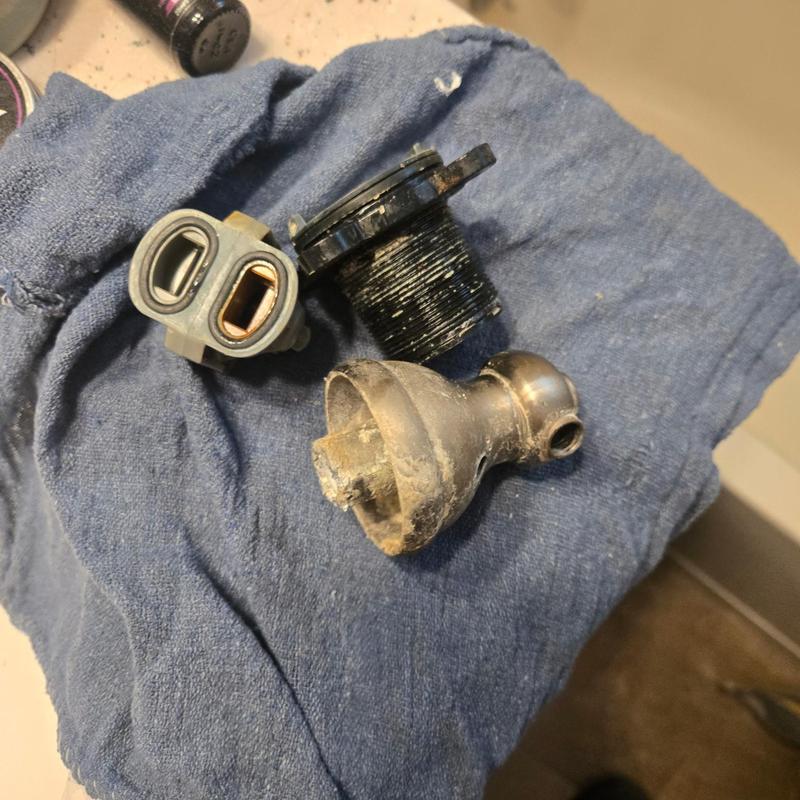 Price Pfister shower valve cartridge parts on towel